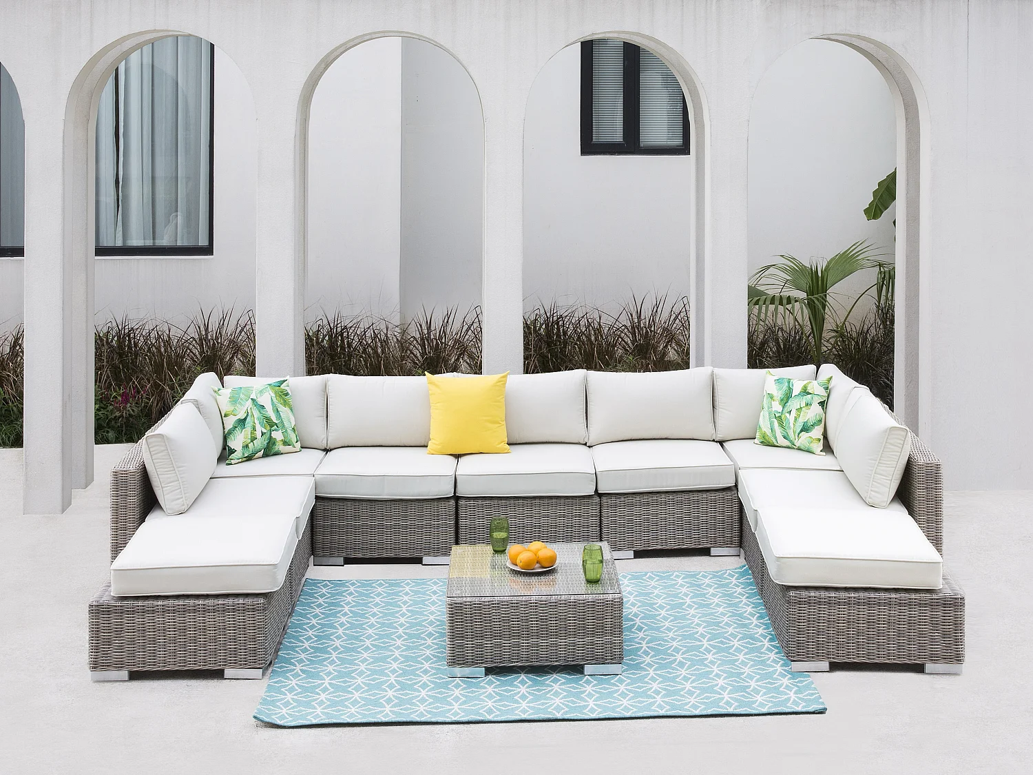 Salon de jardin modulable  en résine tressée: canapé panoramique 7 places, 2 poufs et une table basse - BUSAN de MYLIA