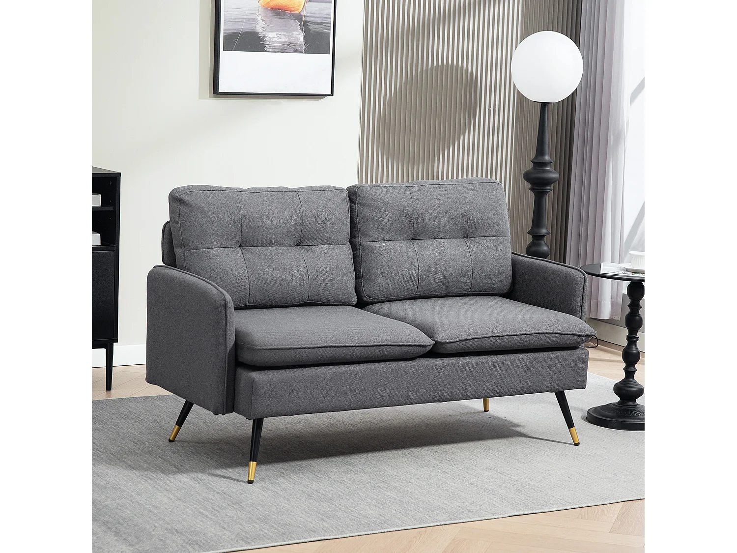 Canapé 2 places style art-déco dossier effet capitonné piètement incliné effilé métal noir extrémités dorées tissu anthracite