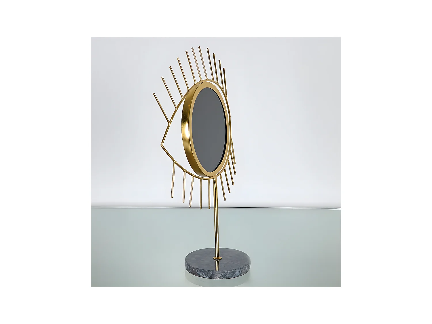 Ojo negro de metal dorado con base de marmol oraculo