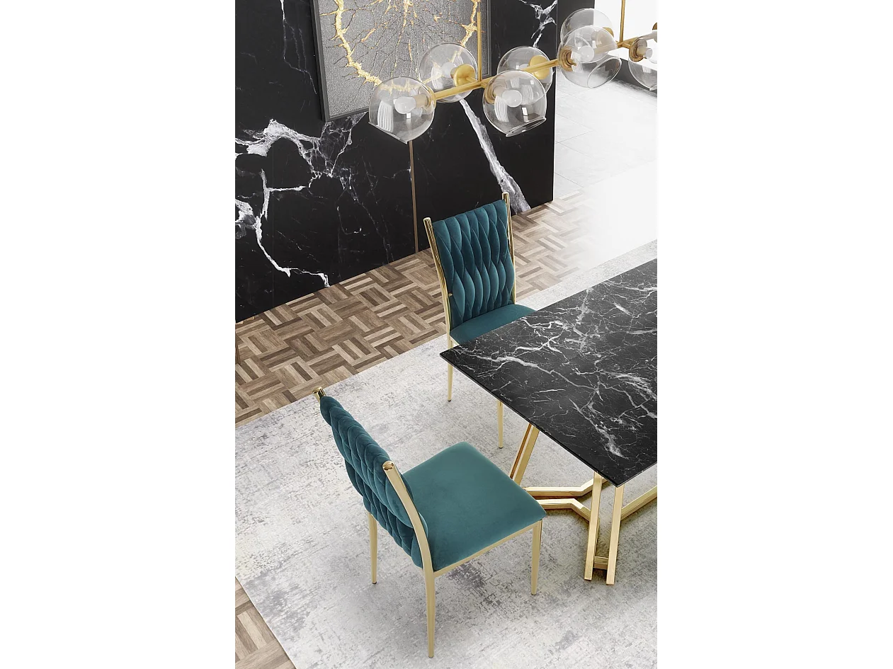 Mesa de comedor CLYTIA con tablero de cristal negro efecto mármol y base de metal dorado