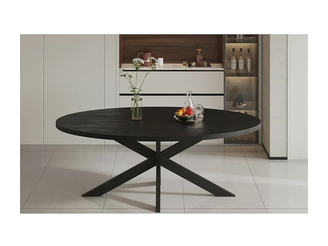 Ovaler Esstisch BOURGIA aus massivem schwarzen Mangolienholz, ideal für ein gemütliches Esszimmer.