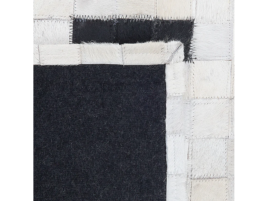 Moderner Teppich schwarz/weiß Echtleder 160 x 230 cm handgefertigt Bolu