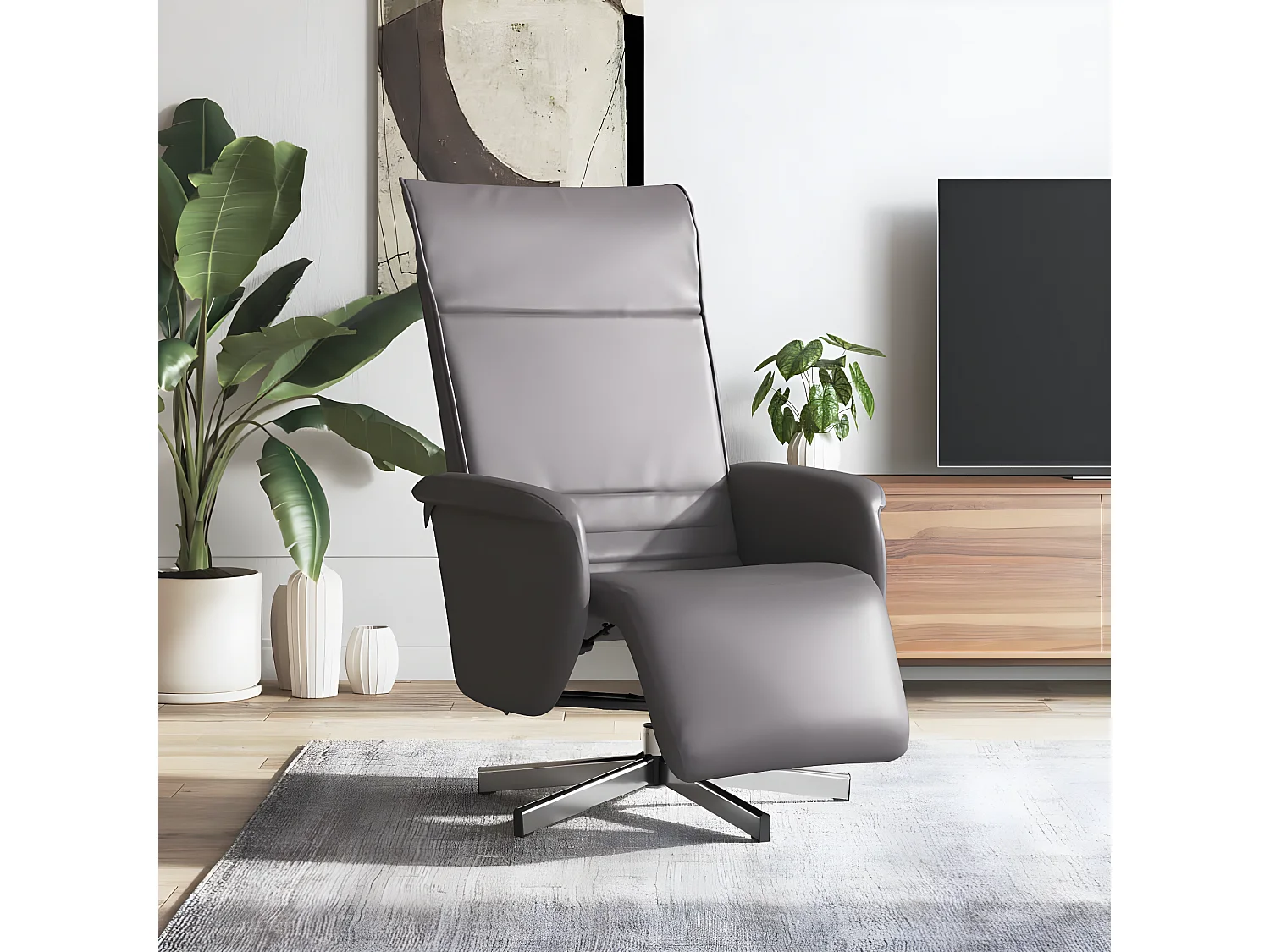 Sillón reclinable con reposapiés de piel sintética gris.