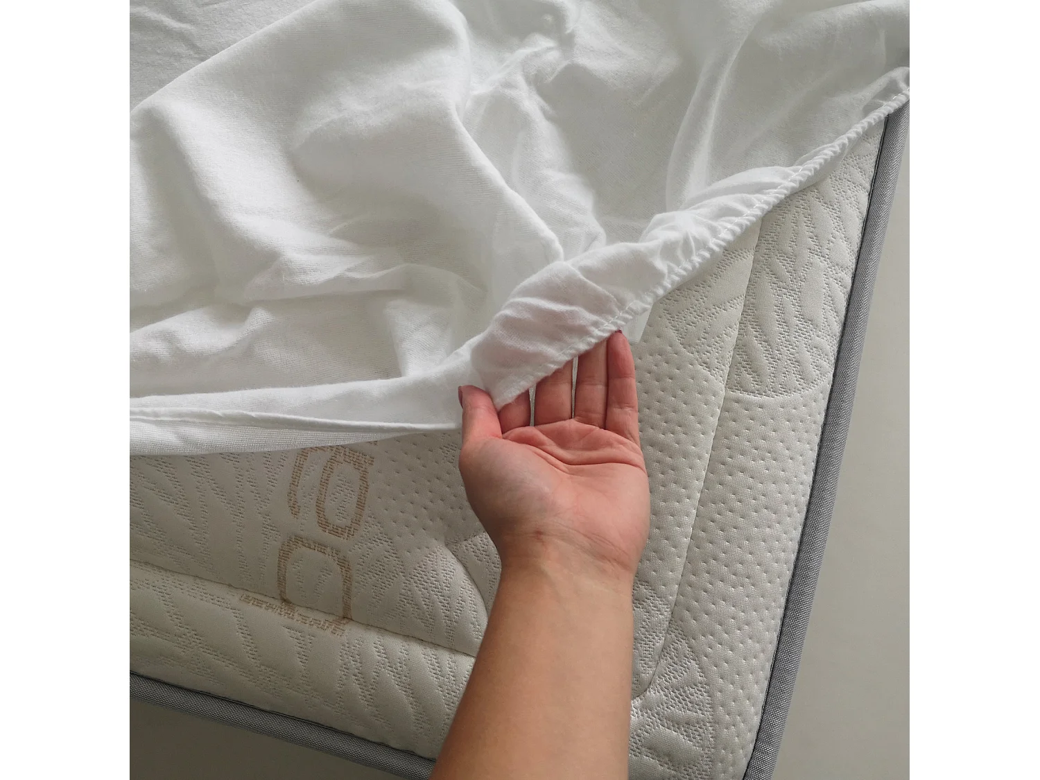 Protège-matelas en forme de drap housse