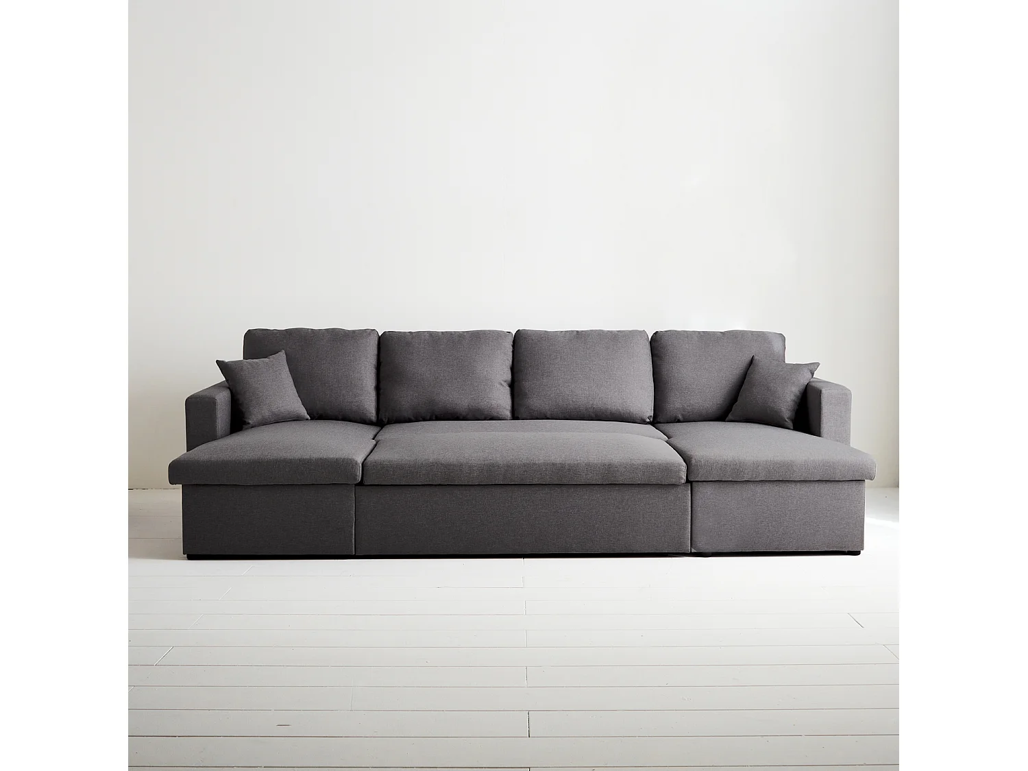 Canapé panoramique convertible en tissu gris foncé. 4 places. coffre rangement. lit modulable