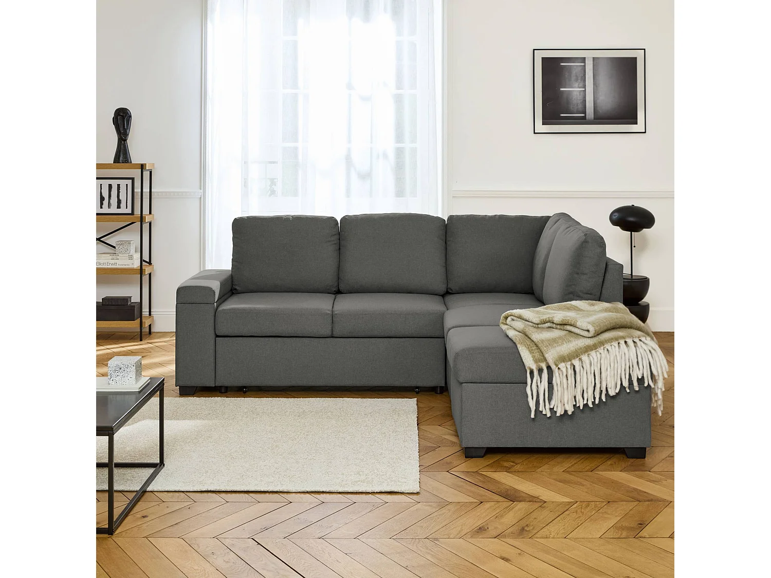 Canapé d'angle convertible. 3 places en tissu gris foncé avec pouf