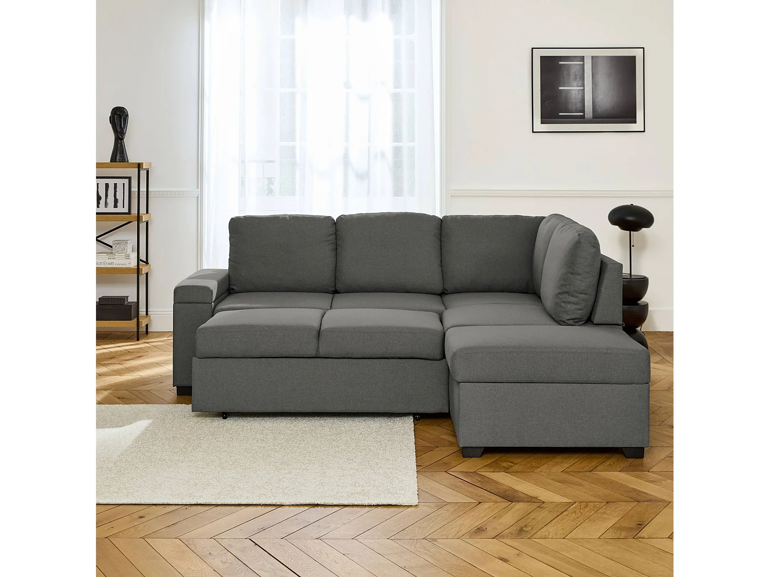 Canapé d'angle convertible. 3 places en tissu gris foncé avec pouf