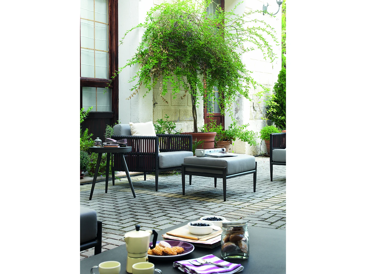 Sillón de aluminio y fibra marrón con cojines de lino