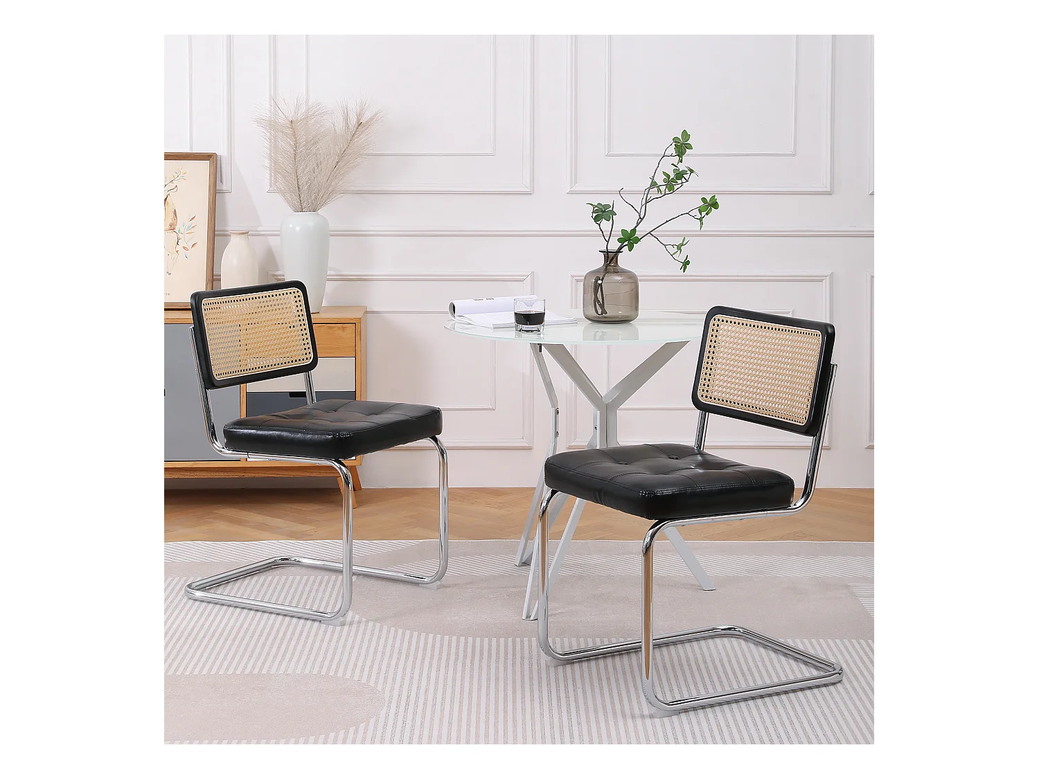 Conjunto de 2 sillas cantilever con respaldo de ratán, en símil piel color negro.