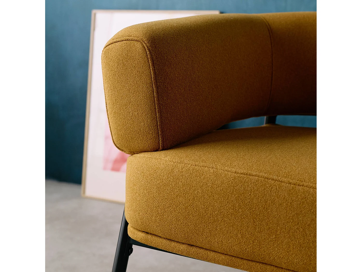 Sillón de tela con respaldo curvo y patas de metal mostaza