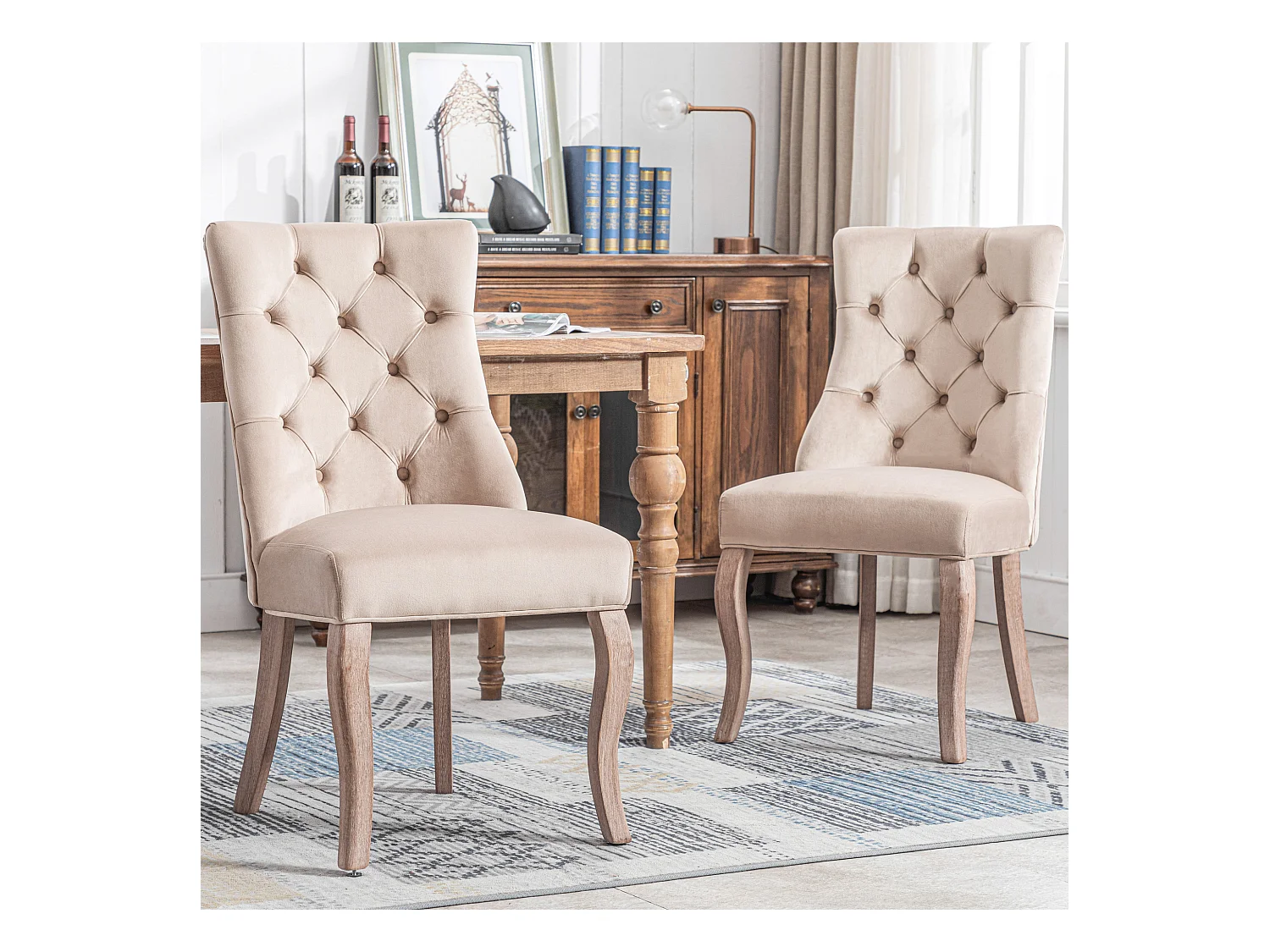 Conjunto de 2 sillas de terciopelo beige con patas de madera curvadas y botones decorativos.