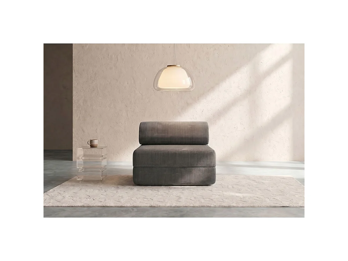 Grijze corduroy fauteuil die omgebouwd kan worden tot fauteuil