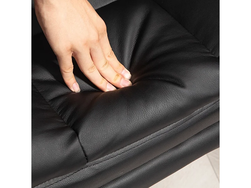 Silla de oficina ergonómica con respaldo reclinable, cojín lumbar, reposapiés, piel sintética negra.