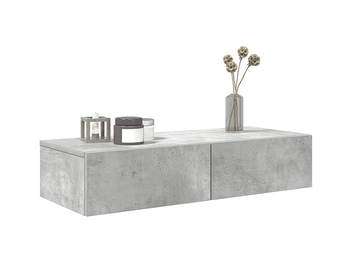 Betongrijze wandplank van bewerkt hout met lades