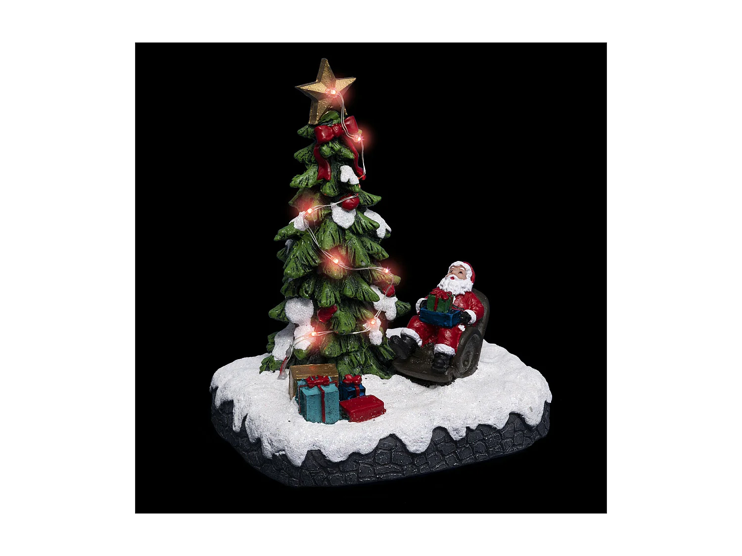 Village de Noël lumineux Père noël dans son fauteuil autour d'un sapin