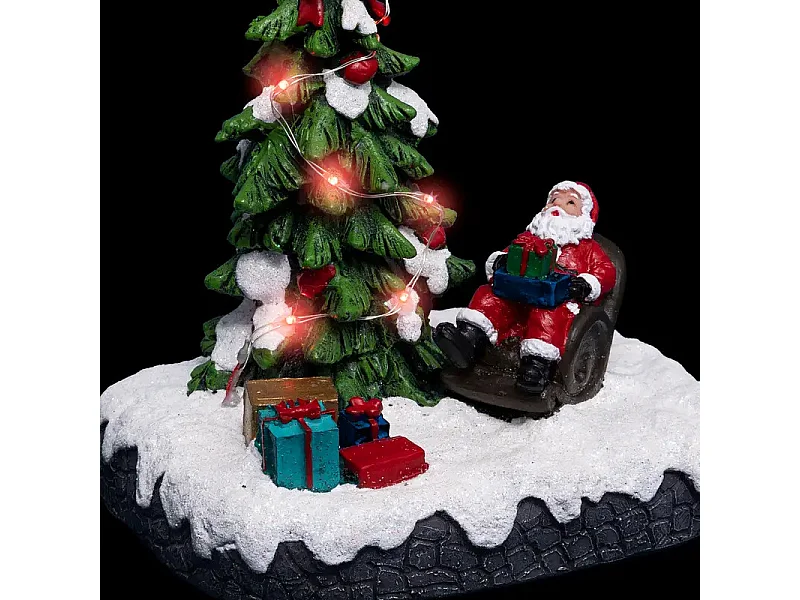 Village de Noël lumineux Père noël dans son fauteuil autour d'un sapin