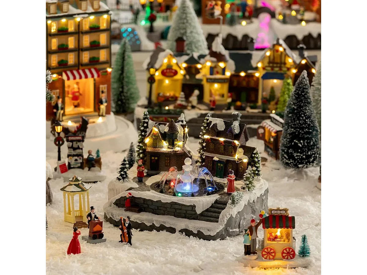 Village de Noël lumineux et mouvement d'eau Scène de vie autour d'une fontaine