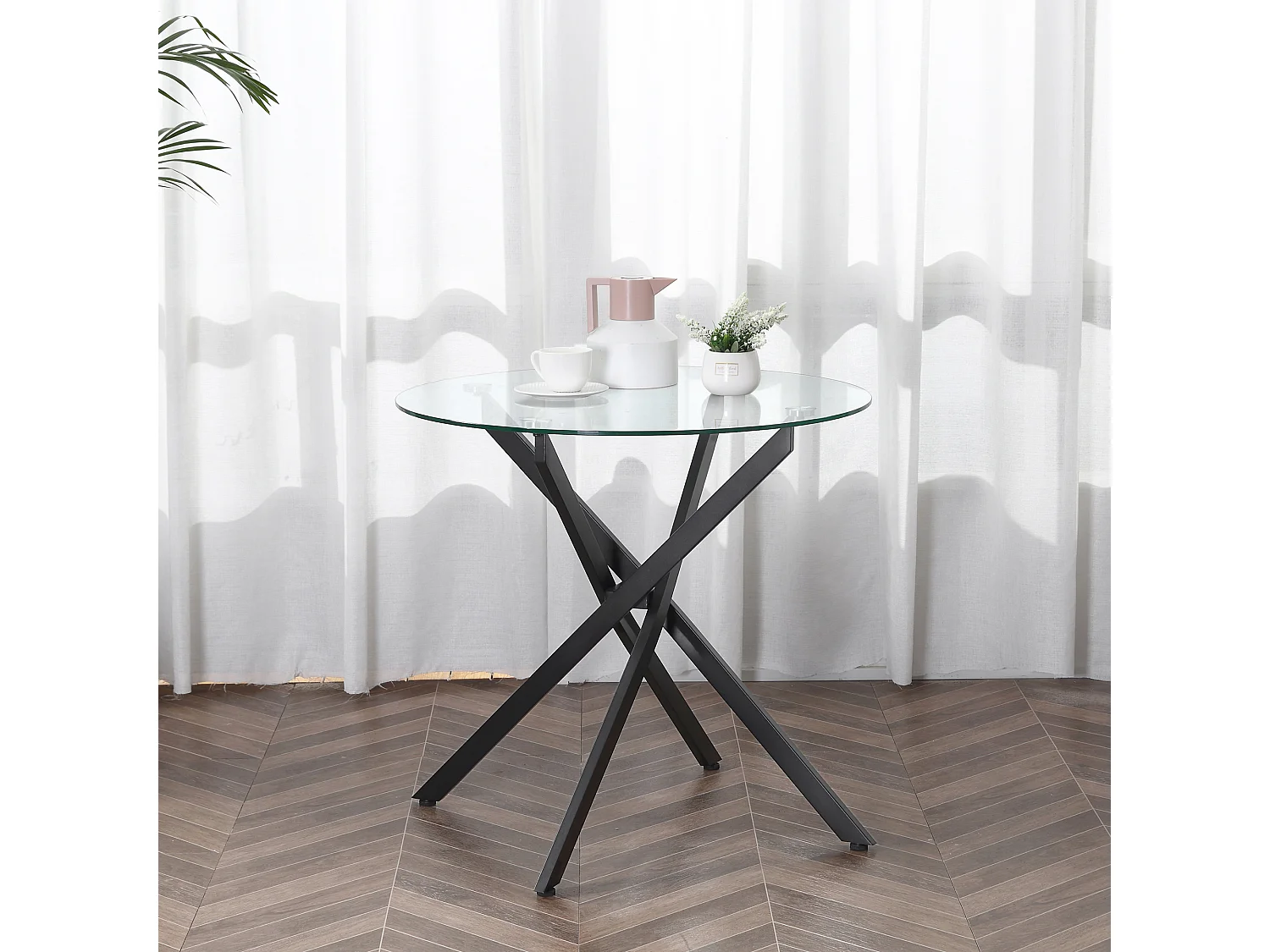 Tavolo da pranzo rotondo in vetro e gambe incrociate in metallo