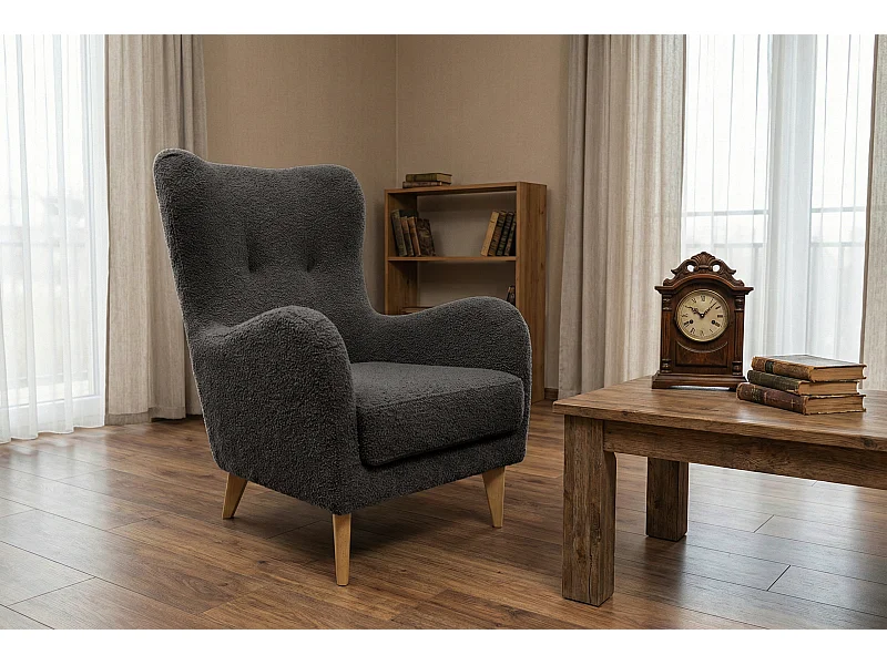 Élégant fauteuil Roland de détente avec assise et dossier profilés.