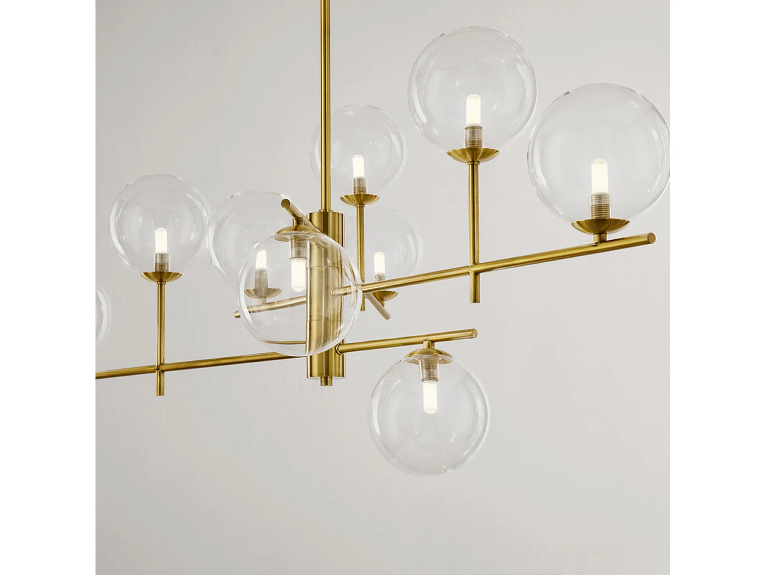 Verstelbare metalen plafondlamp in messing met 9 G9-lichten en diffusers van transparant borosilicaatglas, modern design van het merk Perenz.