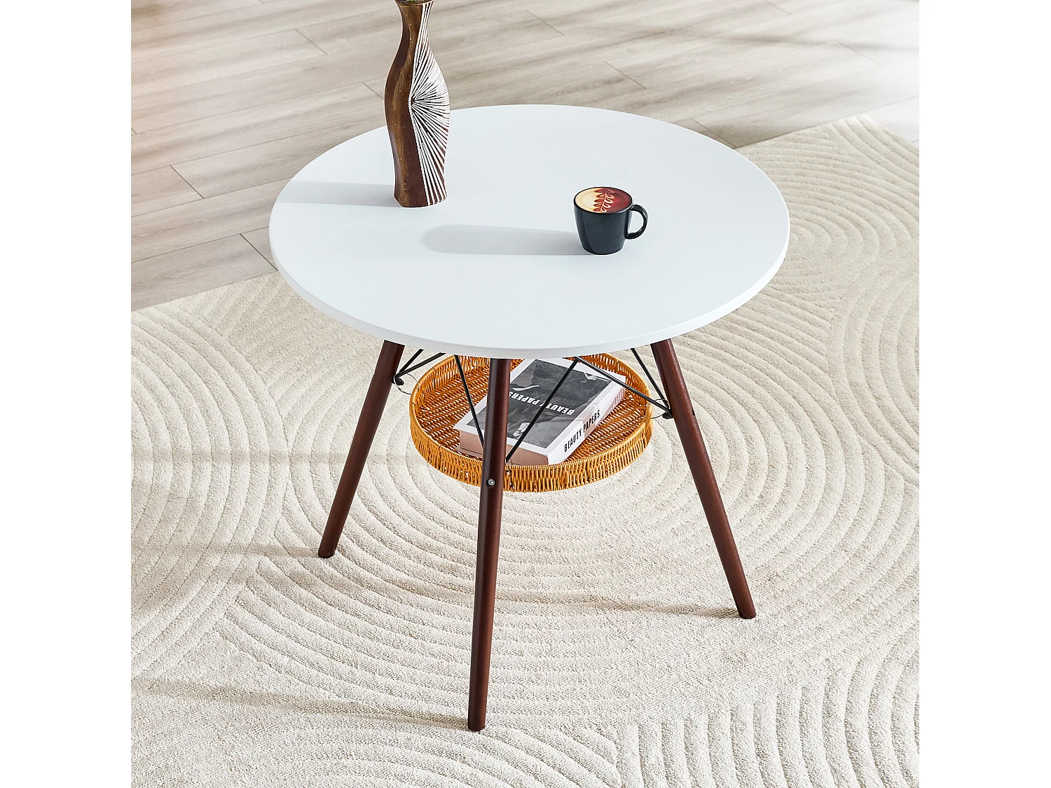 Mesa de jantar redonda, tampo branco, pés cor de nogueira, com uma estrutura de arrumação suspensa em vime, nogueira + branco