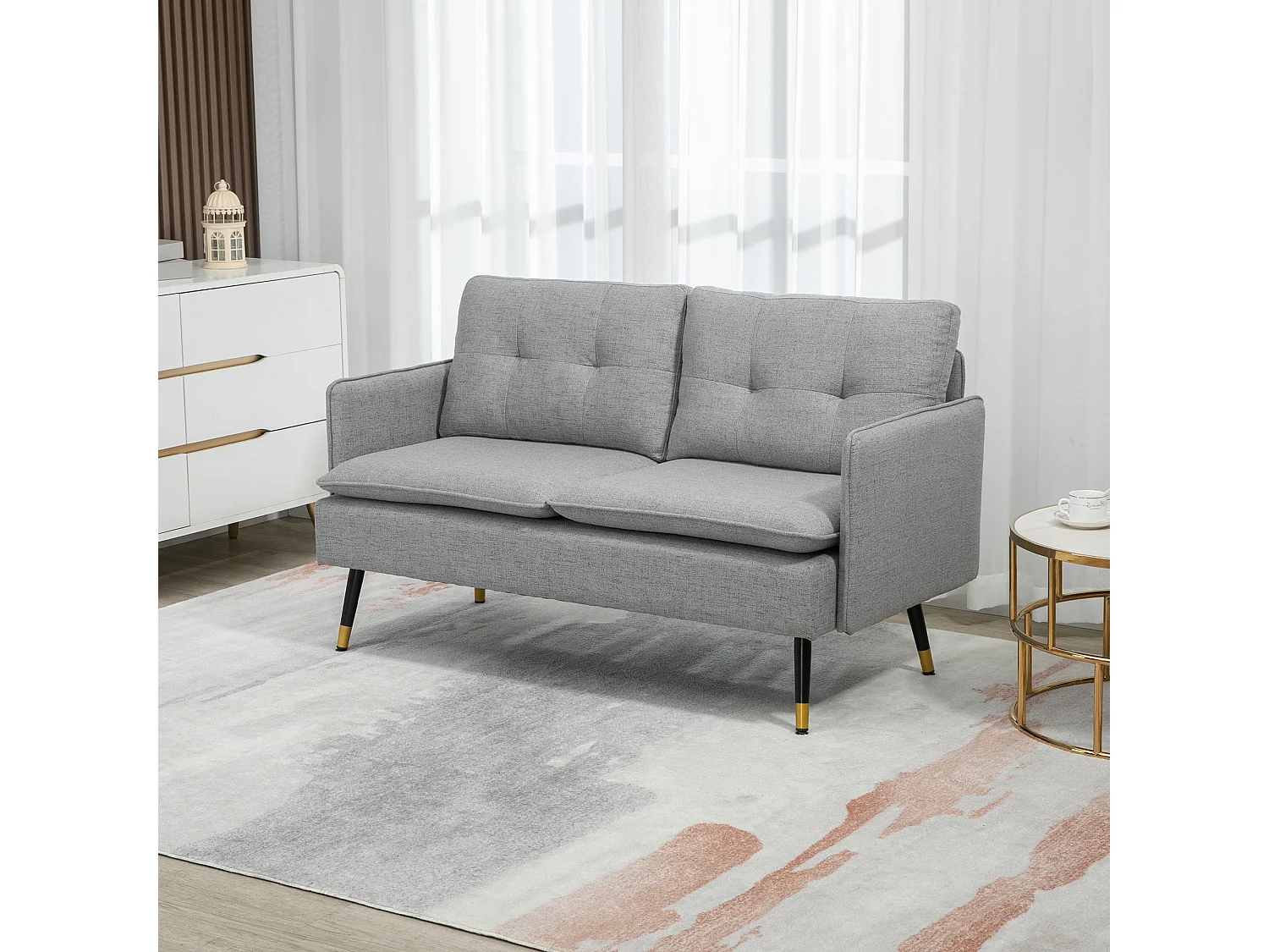 Canapé 2 places style art-déco dossier effet capitonné piètement incliné effilé métal noir extrémités dorées tissu gris