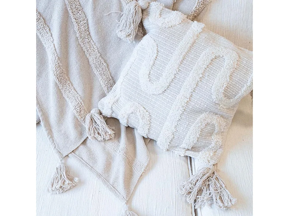 Coussin écru en coton et décor abstrait tissé